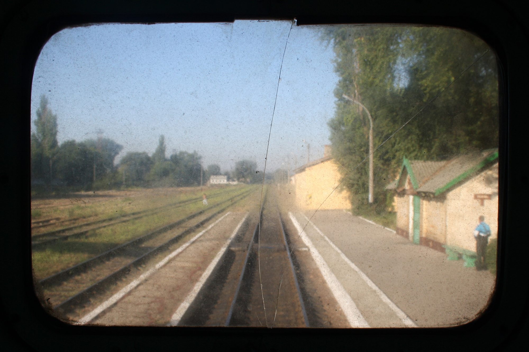 Railway tracks seen through the end window of a train carriage