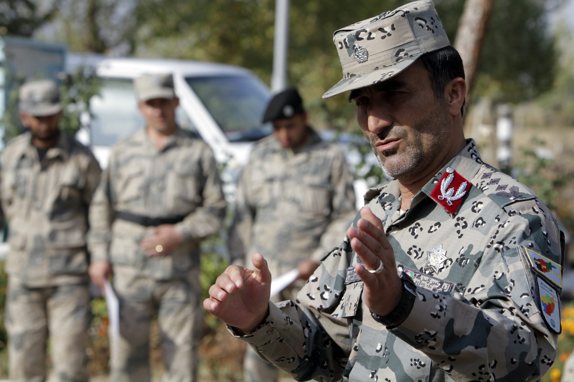 Colonel Sahib Mir Abdulbasir congratulates Afghan border police officers on completing a five-week course in Tajikistan