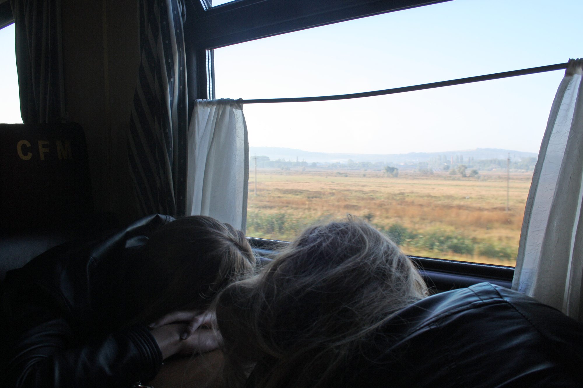 Passengers resting beside a carriage window